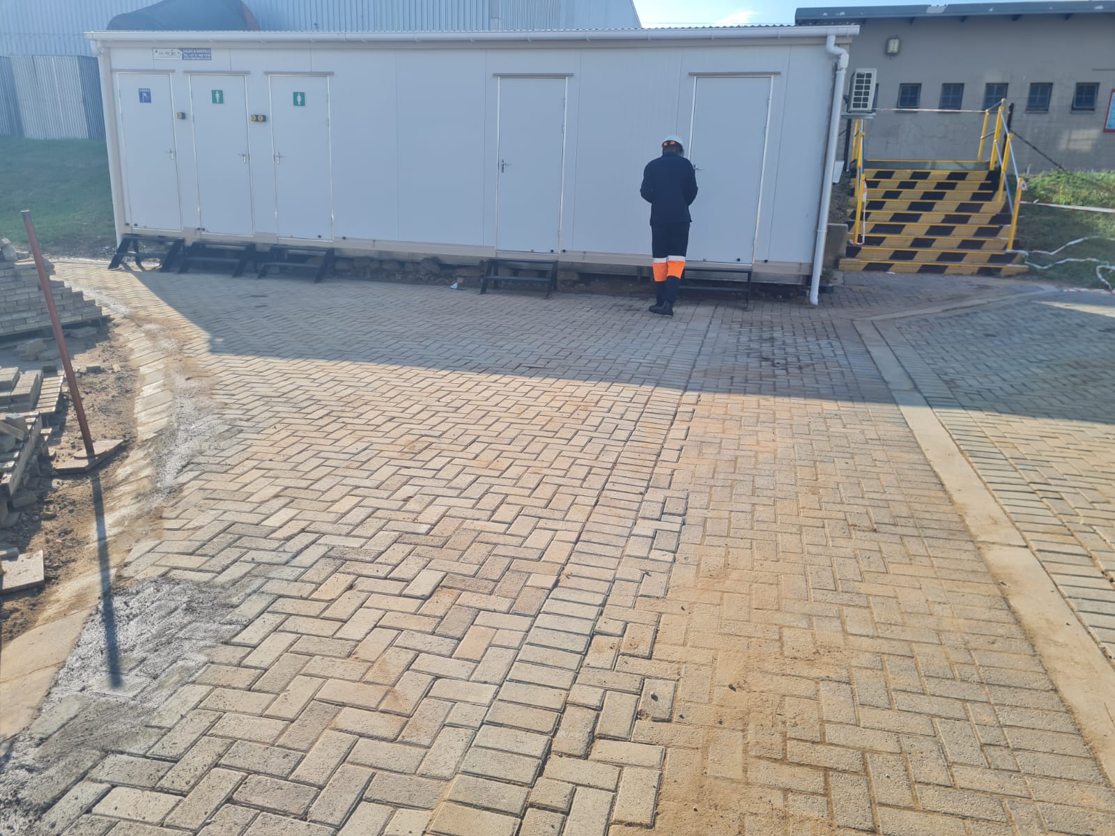 Construction site with paved area, portable facilities, and active work